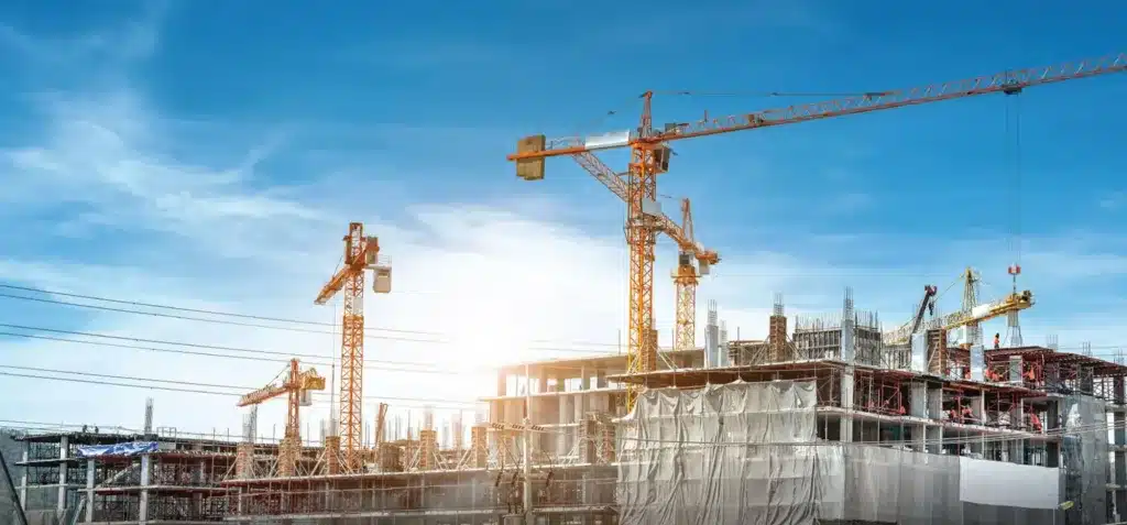 Large cranes in operation at a construction site | image for the SMEs Industries page.
